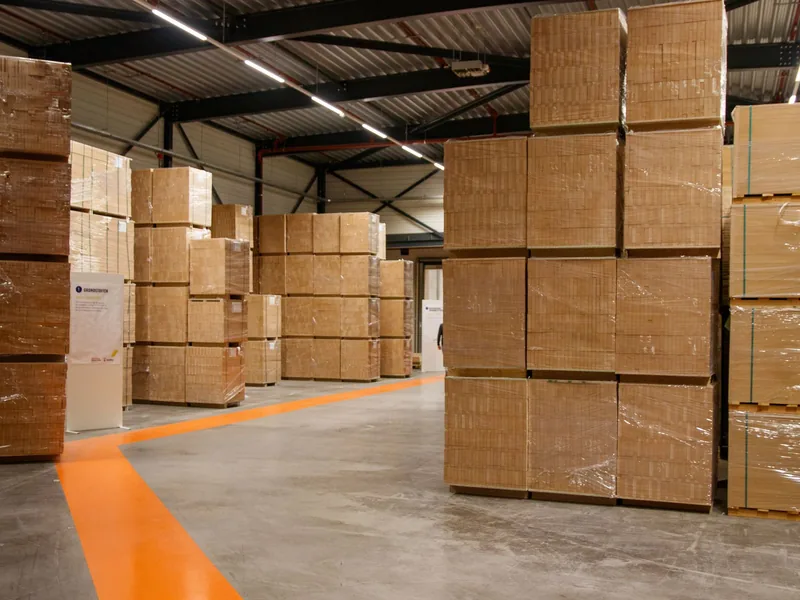 Wholesale warehouse with stacked cartons managed with wholesale software